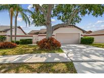 Charming single-story home featuring mature landscaping and a two-car garage at 7035 Drury St, Tampa, FL 33635