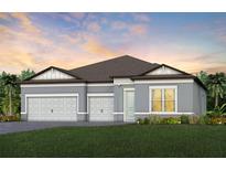 Charming single-story home featuring a three-car garage, and beautifully landscaped front yard with colorful flowers at 6811 Jared Oaks Dr, Wesley Chapel, FL 33545