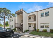 Charming condominium with a landscaped entrance, and a black car parked nearby at 7701 Starkey Rd # 504, Seminole, FL 33777