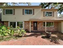 Charming two-story home featuring a brick facade, well-manicured landscaping, and a welcoming entryway at 8350 40Th N Ave, St Petersburg, FL 33709