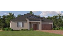 Charming single-story home featuring a brick driveway, a well-manicured lawn, and shuttered windows at 9554 Minnow Ray Dr, Land O Lakes, FL 34638