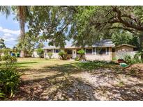 Charming single-story home with mature trees and landscaping at 9802 N Oregon Ave, Tampa, FL 33612