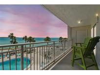 Enjoy the beachfront view from this balcony, complete with outdoor seating and a refreshing pool at 200 1St Ave # 309, St Pete Beach, FL 33706