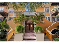 Inviting condo entrance with a private courtyard, mature landscaping, and double-door entry at 200 4Th S Ave # 220, St Petersburg, FL 33701