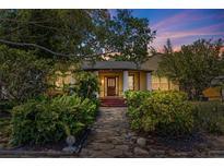 Charming home featuring lush landscaping and a welcoming entrance, under a colorful twilight sky at 202 39Th S Ave, St Petersburg, FL 33705