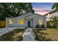 Charming bungalow-style home with blue door, fresh landscaping, and a welcoming walkway to the entrance at 2230 Melrose S Ave, St Petersburg, FL 33712