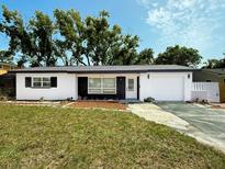 Charming single-story home featuring a manicured lawn and attached garage, perfect for comfortable living at 2254 66Th S Ave, St Petersburg, FL 33712