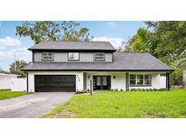 Beautiful two-story home featuring a well-manicured lawn and a two-car garage at 226 Willowick Ave, Temple Terrace, FL 33617