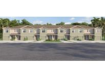 Charming townhomes showcasing manicured landscaping and private garage entrances, inviting curb appeal at 3633 Copper Beech Dr, Land O Lakes, FL 34638