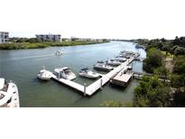 Waterfront condo complex with multiple boat slips, dock, and bay access at 399 2Nd St # 417, Indian Rocks Beach, FL 33785