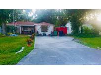 Charming one-story home with a spacious driveway and beautifully landscaped front yard at 4406 W Harbor View Ave, Tampa, FL 33611