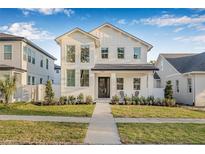 Beautiful two-story home featuring a pristine white exterior, manicured lawn, and inviting front porch seating area at 5120 3Rd N Ave, St Petersburg, FL 33710