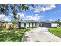 Charming single-story home with a well-manicured lawn and a spacious driveway at 5215 Denver Ne St, St Petersburg, FL 33703