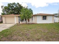 Charming single-story home with stone accents, well-manicured lawn and attached one-car garage at 7904 Judith Cres, Port Richey, FL 34668