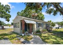 Charming single-story home with brick accents, inviting front entrance, and well-maintained landscaping at 1013 N Bask Dr, Tampa, FL 33603
