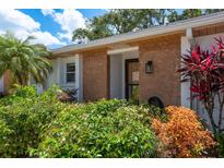 Inviting front entrance with stone accents and lush landscaping creates great curb appeal at 1065 Tartan Dr # C, Palm Harbor, FL 34684