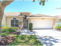 Inviting single-story home with a two-car garage, landscaped front yard and neutral color scheme at 1126 Haley Ln, Dunedin, FL 34698