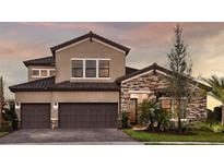 Beautiful two-story home featuring a brick and stucco facade, and a two-car garage at 13726 Heartwood Way, Parrish, FL 34219