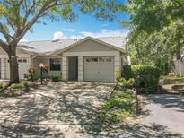 Charming one-story home with a well-maintained lawn, driveway, and attached garage at 1556 Lynda Ln, Dunedin, FL 34698