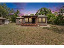 Charming single-story home with a cozy front porch and fresh landscaping at 1920 E Chelsea St, Tampa, FL 33610