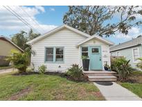 Charming home with a white exterior, light blue door, and well-maintained landscaping at 2015 3Rd S St, St Petersburg, FL 33705