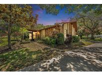 Charming single-story home featuring a stone facade, lush landscaping, and a well-maintained lawn at 2770 Keats Ter # C, Palm Harbor, FL 34684