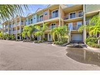 Charming townhouse complex featuring colorful facades, balconies, lush landscaping, and convenient parking at 3282 Mangrove Point Dr, Ruskin, FL 33570