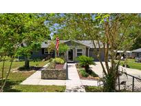 Charming single-story home with stone accents and meticulously landscaped front yard, offering curb appeal at 39252 Kimberly Ave, Zephyrhills, FL 33540