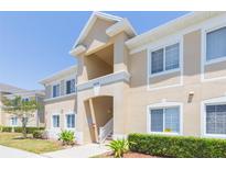 Well-maintained building featuring a beige exterior and white window trim at 9524 Newdale Way # 101, Riverview, FL 33578
