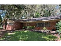 Charming single story brick home with front porch and manicured lawn at 11002 Ridgedale Rd, Temple Terrace, FL 33617