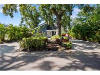 Charming home featuring a lush landscaped front yard and a welcoming entrance with stairs at 1304 Withlacoochee St, Safety Harbor, FL 34695