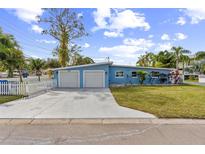 Charming one-story home with a two-car garage, well-maintained lawn and mature trees in a quiet neighborhood at 1818 Indian Rocks Rd S, Largo, FL 33774
