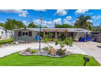 Charming home featuring a landscaped front yard, unique rock features, and a welcoming trellis entrance at 2912 Case Ave, Bradenton, FL 34207
