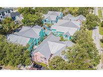 Colorful condo community boasts a pool, mature landscaping, and metal roofs at 3002 W Cleveland St # C3, Tampa, FL 33609
