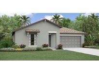 Inviting single-story home featuring a well-manicured lawn, complemented by an attached two-car garage and lush tropical landscaping at 4015 86Th E St, Palmetto, FL 34221