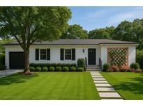 Charming single-story home features a manicured lawn, walkway, and lush landscaping at 4019 W Bay To Bay Blvd, Tampa, FL 33629