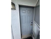 Close-up of a grey front door with unit number 412 and exterior light at 4148 Dolphin Dr # 3, Tampa, FL 33617