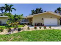 Inviting front yard of a single Gathering home with lush landscaping and a well-manicured lawn at 4174 14Th Ne Ln, St Petersburg, FL 33703
