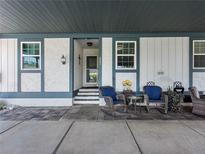 Inviting front porch with outdoor seating, decorative plants, and a welcoming entrance at 4943 New England Blvd # 105, New Port Richey, FL 34652