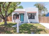 Charming bungalow with a tidy yard, brightly painted door, and eye-catching mailbox at 513 W Paris St, Tampa, FL 33604