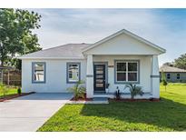 Charming single-story home featuring a modern design, fresh landscaping, and a welcoming entrance at 6215 N 44Th St, Tampa, FL 33610