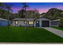 Charming single-story home featuring a well-manicured lawn and a freshly painted exterior at 6347 S Lansdale Cir, Tampa, FL 33616