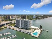 Stunning aerial view of the waterfront condo building and surrounding cityscape with pool, harbor and boat docks at 100 Pierce St # 910, Clearwater, FL 33756
