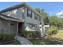 Well-maintained two-story home with manicured landscaping and a welcoming walkway at 11764 Raintree Dr # 0, Temple Terrace, FL 33617