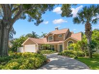 Charming single-Gathering home featuring manicured landscaping, a spacious driveway, and a two-car garage at 13598 Park Blvd, Seminole, FL 33776