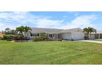 Charming single-story home with a well-manicured lawn and lush tropical landscaping at 1382 52Nd Ne Ave, St Petersburg, FL 33703