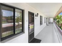 Inviting hallway featuring neutral colors, leading to residences with natural light, creating a serene and welcoming atmosphere at 172 Lakeview Way # 172, Oldsmar, FL 34677
