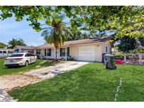 Charming single-story home with a well-manicured lawn and cozy curb appeal at 1720 Chrysler Ave, Sarasota, FL 34234