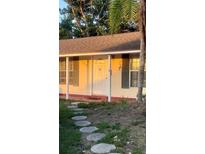 Charming single-story home featuring a decorative front door and stone walkway at 1720 Chrysler Ave, Sarasota, FL 34234
