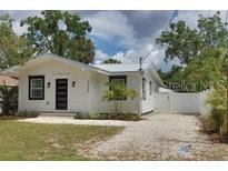 Charming home with a well-maintained lawn and gravel driveway at 3008 E 38Th Ave, Tampa, FL 33610